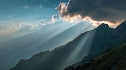 Sunbeams breaking through clouds over mountain ridge in peaceful morning light