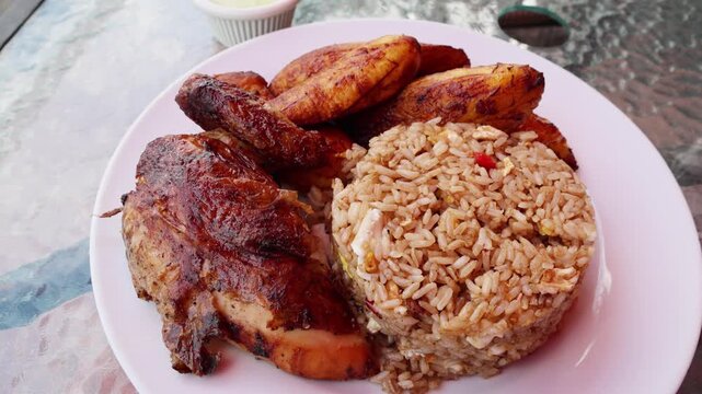 peruvian fried chicken dish with pork and egg fried rice fried sweet plantains and spicy green sauce (peru cuisine restaurant special meal ossining new york) white plate rotisserie pollo asian fusion