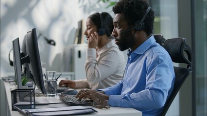 Diverse callcenter collaboration Caucasian boss explaining task pointing finger African operator...