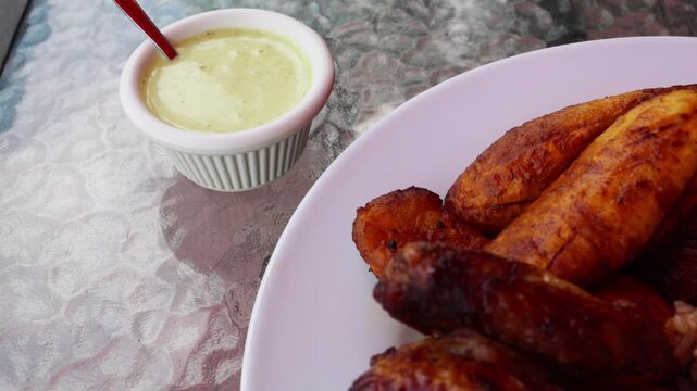 peruvian fried chicken dish with pork and egg fried rice fried sweet plantains and spicy green sauce (peru cuisine restaurant special meal ossining new york) white plate rotisserie pollo asian fusion