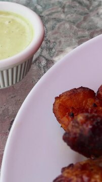 peruvian fried chicken dish with pork and egg fried rice fried sweet plantains and spicy green sauce (peru cuisine restaurant special meal ossining new york) white plate rotisserie pollo asian fusion