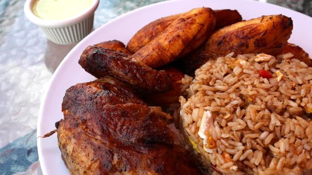 peruvian fried chicken dish with pork and egg fried rice fried sweet plantains and spicy green sauce (peru cuisine restaurant special meal ossining new york) white plate rotisserie pollo asian fusion