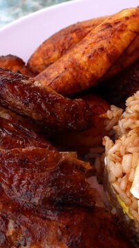peruvian fried chicken dish with pork and egg fried rice fried sweet plantains and spicy green sauce (peru cuisine restaurant special meal ossining new york) white plate rotisserie pollo asian fusion
