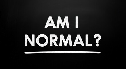 The question of being normal written in chalk on a black chalkboard