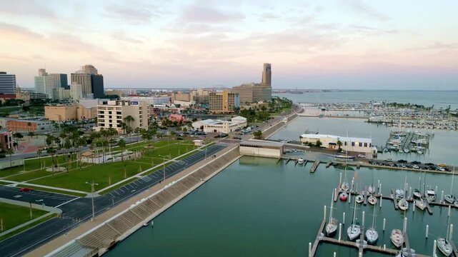 Aerial view of corpus christi skyline at dusk with marina and boats