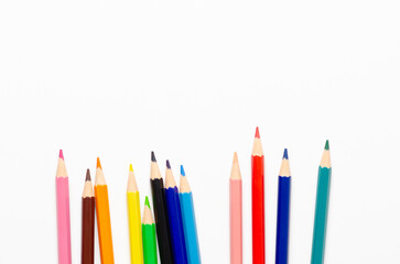 Collection of colorful sharpened pencils on a white background with copy space.