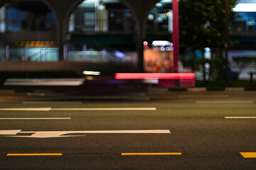 blurred transportation and city lights at night in urban street scene