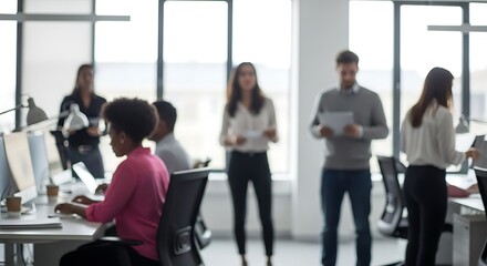 Diverse team of professionals collaborating in a modern, open-plan office with a blurred background focus on a busy work environment