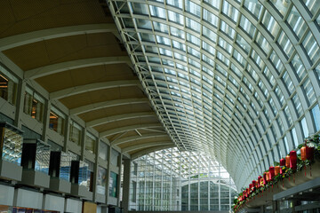 Wide-angle view of a shopping mall's architectural glass roof adorned