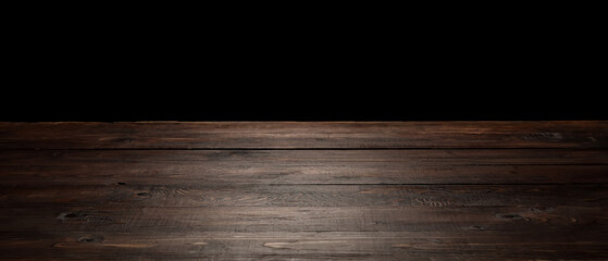 Wooden table top on black background
