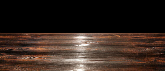 Wooden table top on black background