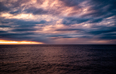 Beautiful sunset on the sea from a cruise ship dark skies water calm scenic milford sound new zealand stunning