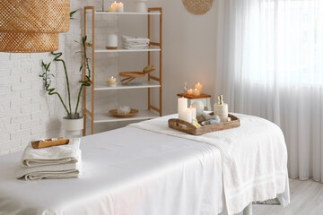 Interior of spa salon with couch and burning candles