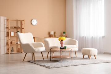 Modern interior of living room with sofa, armchair and daffodil flowers