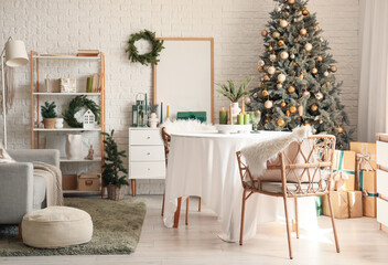 Interior of dining room with table, sofa and Christmas tree