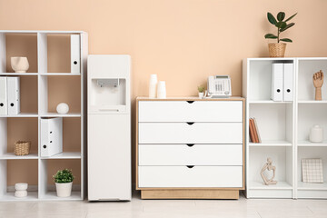 Fototapeta premium Interior of stylish office with modern water cooler and shelving units