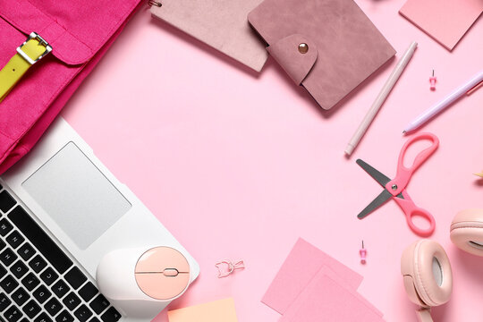 Frame made of modern laptop and school supplies on pink background - Powered by Adobe