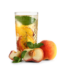 Glass of fresh peach lemonade with mint and fruits on white background