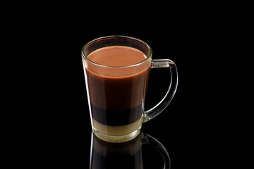 Milk coffee in transparent cup isolated on black background with clipping path.