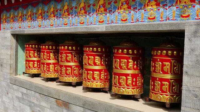 Rotating brass prayer wheels in Nepal monastery. Buddhist symbols, mantra engraving, spinning motion, cultural heritage, traditional ritual, spiritual architecture, Himalayas stock video
