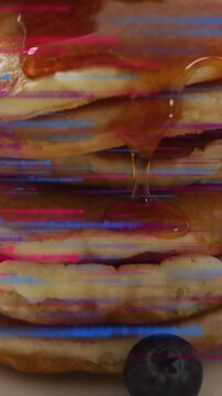 Pancakes topped with syrup and blueberries, glitch effect animation background