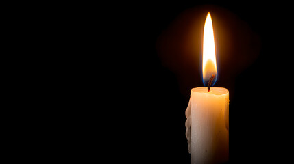 A solitary white candle burns brightly and cleanly, casting a warm glow in profound darkness.
