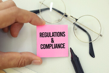 judge's hammer and book with the words regulations and compliance. comply with regulations, such as...