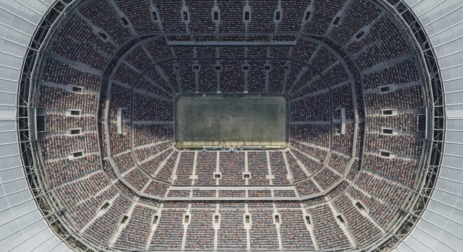 Captivating Aerial View of a Packed Football Stadium Under Bright Lights Showcasing Exciting Game Action