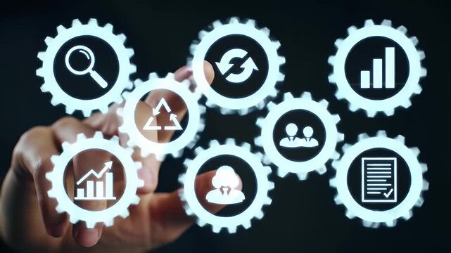 Hand Touching Glowing Gears with Business Strategy Icons on Dark Blue Backdrop Concept for Innovation Finance and Technology Management Adobe Stock Photo