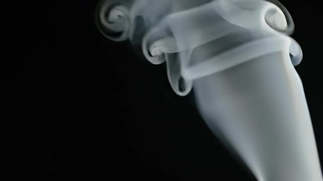 Mesmerizing flow of white smoke on black background in slow motion sequence