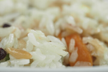Colorful rice dish with vegetables and nuts close up