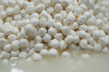 Cheese balls piled on a white surface ready for use