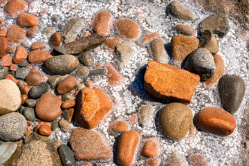 Red rocks and salt crystals creating a colorful pattern in Arbatax, Sardinia
