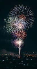 Spectacular fireworks illuminate the night sky above the city skyline celebration