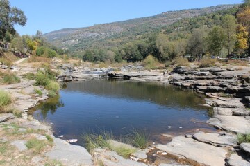 Peaceful river pool nestled in a rocky valley