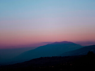 Obraz premium pink sky, gradient upper black,shadow of a mountain in the center