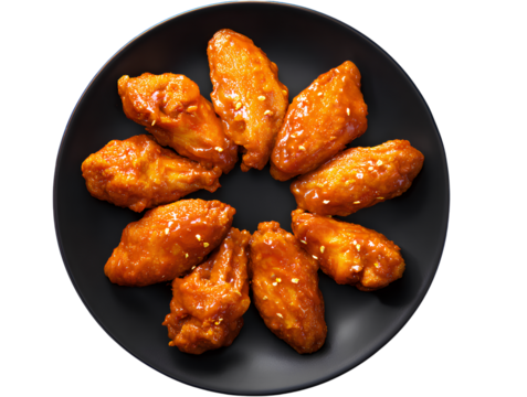  Top view of spicy buffalo chicken wings arranged in a circular pattern on a matte black ceramic plate, vibrant orange glaze shining under soft lighting