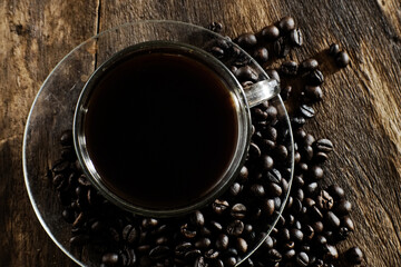 Cup of coffee on wooden table with copy space background, Half cup of coffee, Still life and sketch in dark tones, Top view for advertising, Business and Drink Concept