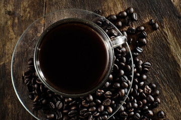 Cup of coffee on wooden table with copy space background, Half cup of coffee, Still life and sketch in dark tones, Top view for advertising, Business and Drink Concept
