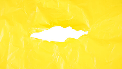 Crumpled yellow plastic with ripped hole in the middle of the surface isolated on transparent background