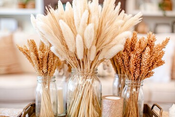 Dried grasses in mason jars on a tray