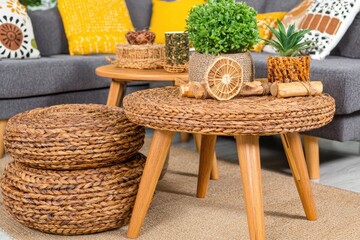 Woven round coffee tables and poufs in a cozy living room