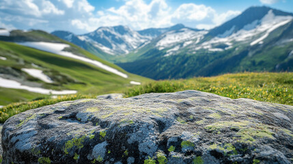 Close-up of rugged mountain rock surface with blurred background showing snow-capped peaks, green slopes, and valley. Scenic natural outdoor landscape ideal for travel, adventure, and product display.