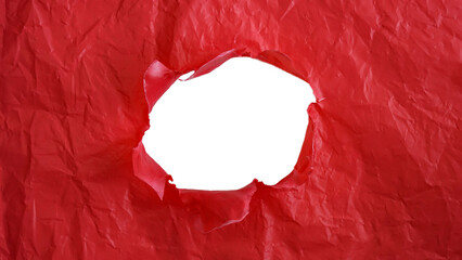 Crumpled red plastic with ripped hole in the middle of the surface isolated on transparent...