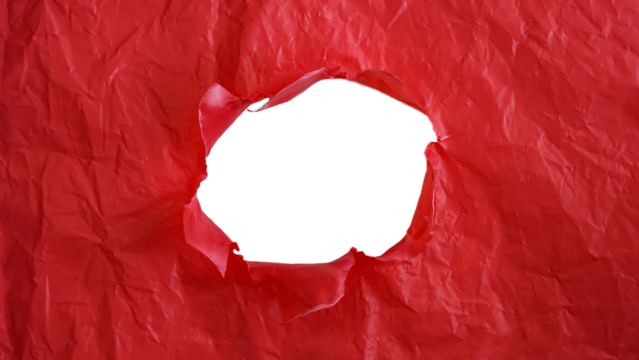 Crumpled red plastic with ripped hole in the middle of the surface isolated on transparent background