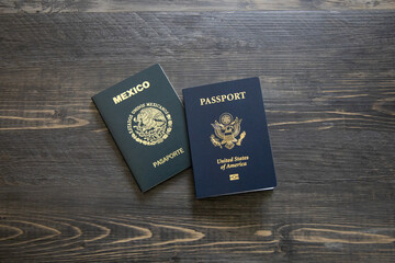 Mexican and American passports. Two passports with dark wooden background.