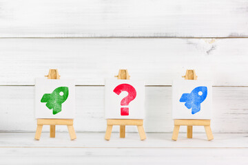 Creative Decision-Making Concept with Rocket Symbols and Question Mark on Mini Easels