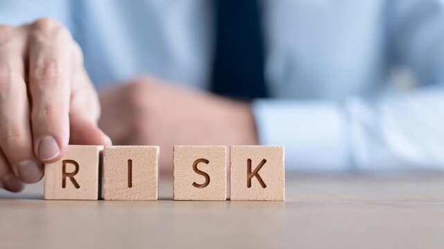 Wooden blocks with the word Risk and a team with a leader Business concept of teamwork Financial Crisis Economic Business risk management concept Business planning Risk assessment Forecast