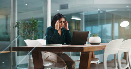 Woman, headache and anxiety with laptop in office for mistake, financial crisis or debt. Female person, employee or accountant with migraine, stress or strain on computer for deadline or bankruptcy