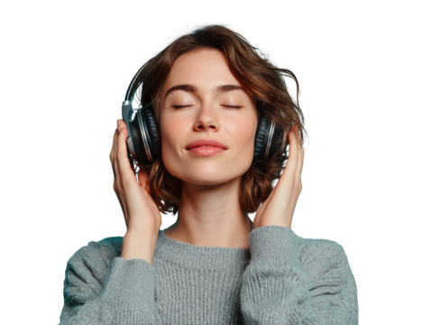 A woman wearing headphones is smiling and appears to be enjoying her music